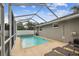Screened-in pool with lounge chairs and a sunny patio at 205 W 122Nd Ave, Tampa, FL 33612