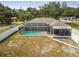 Aerial view of a screened in pool and covered lanai provides a relaxing backyard experience at 205 W 122Nd Ave, Tampa, FL 33612