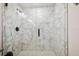 Elegant walk-in shower featuring marble-look tile and modern fixtures at 205 W 122Nd Ave, Tampa, FL 33612