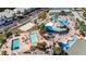 A sprawling resort showcasing multiple pools, lounge chairs, lush landscaping, and activity areas at 21007 Sunpoint Way # 203, Lutz, FL 33558