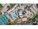 Aerial view of a community featuring a large pool and deck area with tennis courts at 21007 Sunpoint Way # 203, Lutz, FL 33558