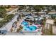 Aerial view of resort-style community amenities, including multiple pools, lounge areas, and palm trees at 21007 Sunpoint Way # 203, Lutz, FL 33558