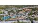 Aerial view of a resort with pools, tennis courts, parking, and surrounding buildings and green space at 21007 Sunpoint Way # 203, Lutz, FL 33558