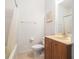 This bathroom features a shower/tub combo and a wood vanity with a sink at 21007 Sunpoint Way # 203, Lutz, FL 33558