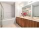 This primary bathroom includes a soaking tub, a walk-in shower, and a double sink at 21007 Sunpoint Way # 203, Lutz, FL 33558