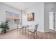 Bright dining area features a glass table, modern chandelier, and window with neighborhood view at 21007 Sunpoint Way # 203, Lutz, FL 33558