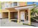 View of home entrance featuring a white door, and one-car garage at 21007 Sunpoint Way # 203, Lutz, FL 33558