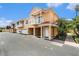 Two-story townhome boasts a private balcony, tile roof, attached garage, and landscaped grounds at 21007 Sunpoint Way # 203, Lutz, FL 33558