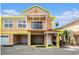 Charming two-story townhome featuring a balcony, tiled roof, and attached garages in a well-maintained community at 21007 Sunpoint Way # 203, Lutz, FL 33558