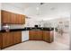Open kitchen with granite counters and wood cabinets with stainless steel sink and dishwasher at 21007 Sunpoint Way # 203, Lutz, FL 33558
