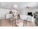Open living space with modern lighting, comfortable seating, and a view into the kitchen area at 21007 Sunpoint Way # 203, Lutz, FL 33558