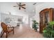 Spacious living room featuring wood floors, ceiling fan, and access to an outdoor balcony at 21007 Sunpoint Way # 203, Lutz, FL 33558