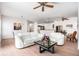 Cozy living room with dining area featuring contemporary furniture, natural lighting, and hardwood floors at 21007 Sunpoint Way # 203, Lutz, FL 33558