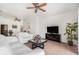 Bright living room featuring modern furniture, a ceiling fan, and view into adjacent rooms at 21007 Sunpoint Way # 203, Lutz, FL 33558