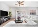 Bright, open living area with sliding glass doors, ample seating, and stylish entertainment center at 21007 Sunpoint Way # 203, Lutz, FL 33558