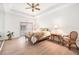 Well-lit main bedroom with wood floors, ceiling fan, and slider doors to the outside at 21007 Sunpoint Way # 203, Lutz, FL 33558
