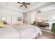 Main bedroom with a ceiling fan, double door closet, and decorative mirror feature at 21007 Sunpoint Way # 203, Lutz, FL 33558