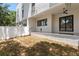 This home features a large backyard with a covered patio and white privacy fence at 218 Hesperides N St, Tampa, FL 33609