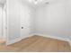 Bright bedroom featuring light hardwood floors, white walls, and modern lighting at 218 Hesperides N St, Tampa, FL 33609