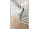 Elegant entryway with wood staircase, black metal spindles and hardwood floors at 218 Hesperides N St, Tampa, FL 33609