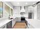 Modern kitchen featuring gray cabinets, white countertops, stainless steel appliances, and hardwood floors at 218 Hesperides N St, Tampa, FL 33609