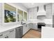 Modern kitchen featuring gray cabinets, white countertops, stainless steel appliances, and hardwood floors at 218 Hesperides N St, Tampa, FL 33609