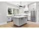 Modern kitchen featuring gray cabinets, white countertops, stainless steel appliances, and hardwood floors at 218 Hesperides N St, Tampa, FL 33609
