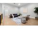 Cozy living room with wood floors, a modern sofa, stylish seating, and a patterned rug at 218 Hesperides N St, Tampa, FL 33609