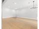 Bright open-concept living room featuring light hardwood floors and modern lighting at 218 Hesperides N St, Tampa, FL 33609