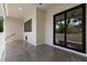 The back patio features recessed lights, gray tile flooring and leads to a fenced backyard at 218 Hesperides N St, Tampa, FL 33609