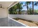 This covered patio features a modern design and overlooks the fenced in back yard at 218 Hesperides N St, Tampa, FL 33609