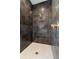 Modern walk-in shower with a rainfall shower head and beautiful tile surround at 218 Hesperides N St, Tampa, FL 33609