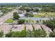 Aerial view featuring properties with solar panels and green spaces, set against a backdrop of community buildings at 2216 Evans Rd, Clearwater, FL 33763