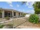 View of the backyard, featuring a screened porch, decorative statue, and a privacy fence, offering a serene outdoor retreat at 2216 Evans Rd, Clearwater, FL 33763