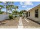 Backyard featuring a stone pathway, a privacy fence, offering an outdoor space for relaxation and recreation at 2216 Evans Rd, Clearwater, FL 33763