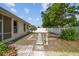 Spacious backyard featuring a stone pathway, decorative statue, and a privacy fence, offering a serene outdoor retreat at 2216 Evans Rd, Clearwater, FL 33763