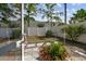 View of backyard from screened porch, featuring a statue, a privacy fence, offering a serene outdoor retreat at 2216 Evans Rd, Clearwater, FL 33763