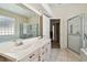 Bathroom showcasing a double vanity, glass shower, and tile flooring at 2216 Evans Rd, Clearwater, FL 33763