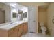 Bright bathroom features a tiled floor, single sink vanity with a cream countertop, and a white toilet at 2216 Evans Rd, Clearwater, FL 33763