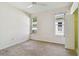 Neutral bedroom with carpeting, ceiling fan, and two windows providing natural light at 2216 Evans Rd, Clearwater, FL 33763