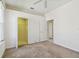 Neutral bedroom with carpeting, ceiling fan, closet, and two doors to adjacent rooms at 2216 Evans Rd, Clearwater, FL 33763