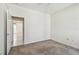 Neutral bedroom with carpeting and a ceiling fan, plus a view to the tiled hallway and other rooms at 2216 Evans Rd, Clearwater, FL 33763