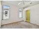 Bedroom features carpeting, ceiling fan, and two windows for natural lighting, plus a walk-in closet at 2216 Evans Rd, Clearwater, FL 33763