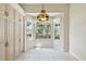 Bright breakfast nook featuring a large bay window overlooking the landscaped yard and a charming stained-glass light fixture at 2216 Evans Rd, Clearwater, FL 33763