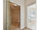 Walk-in closet leading into a bright bathroom with a glass-enclosed shower and separate tub at 2216 Evans Rd, Clearwater, FL 33763