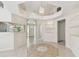 Inviting entryway boasting tile floors, chandelier, and seamless flow to adjacent living spaces at 2216 Evans Rd, Clearwater, FL 33763