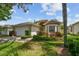 Charming one-story home with a two-car garage, lush landscaping, bay window, and covered entryway at 2216 Evans Rd, Clearwater, FL 33763