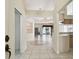 An open-concept foyer with tile floors, a chandelier, and views of the kitchen and living areas at 2216 Evans Rd, Clearwater, FL 33763