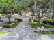Charming one-story home with a two-car garage, driveway, mature trees and manicured landscaping at 2216 Evans Rd, Clearwater, FL 33763