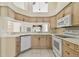 Well-lit kitchen with sleek countertops, a white appliance package, and light-colored cabinetry at 2216 Evans Rd, Clearwater, FL 33763